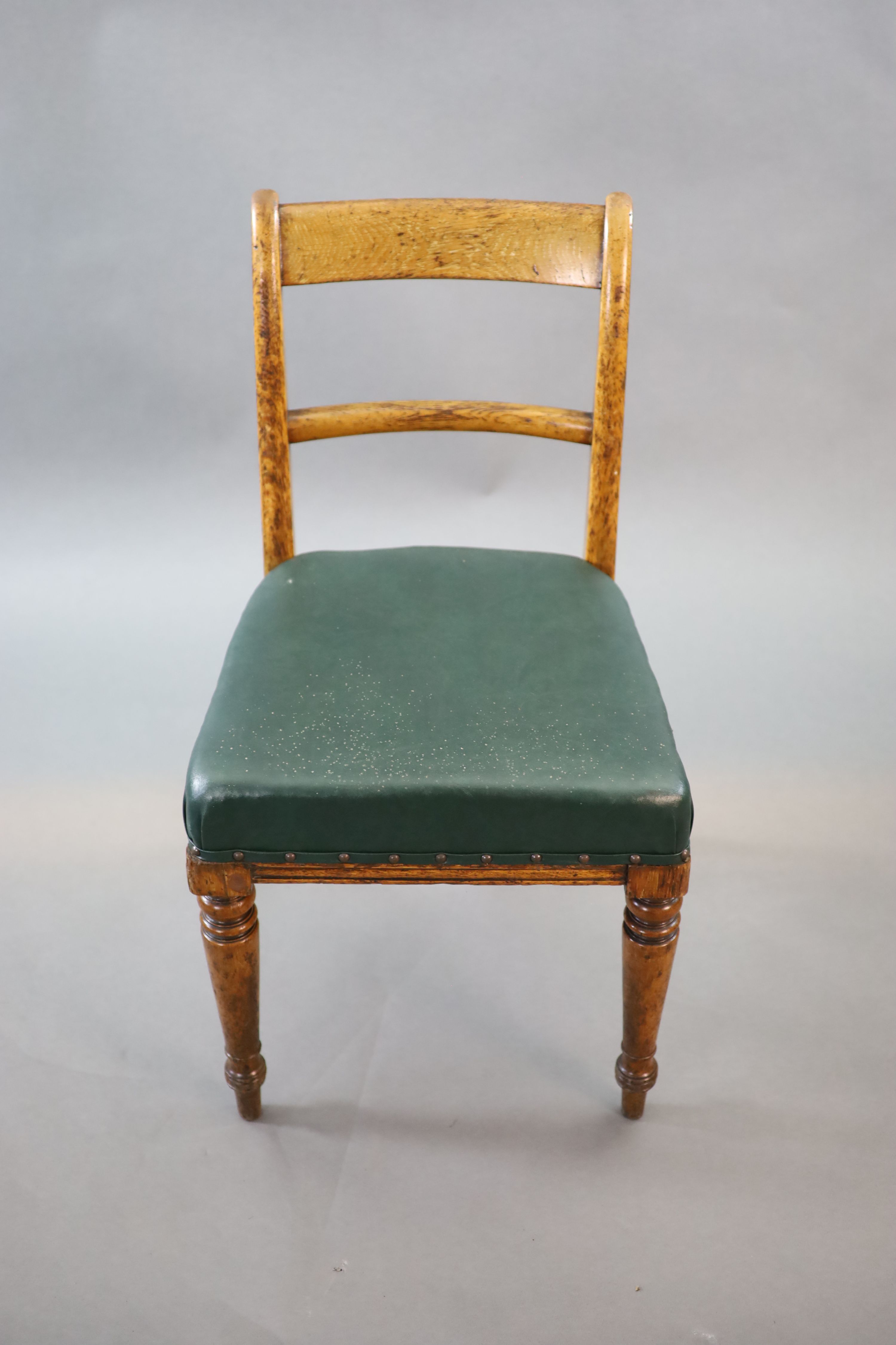 A set of eight early Victorian oak dining chairs